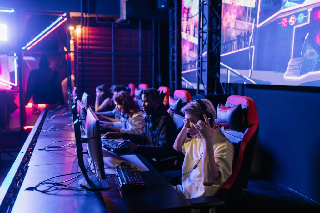 pexels-photo-7862518-7862518 Focused gamers in a high-tech arena compete intensely, showcasing esports fervor.
